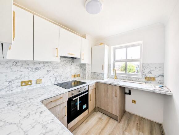 Bright modern kitchen with marble worktops...