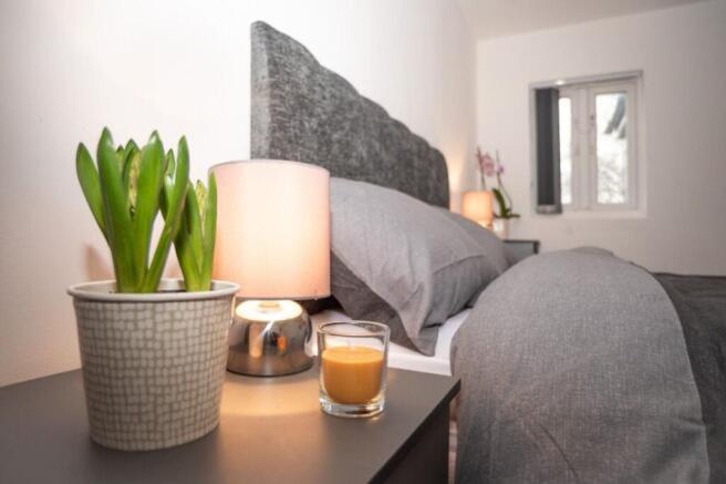 This inviting double bedroom features a cozy am...