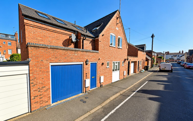 Sunny Brick Townhouses and Blue Garage Doors.png