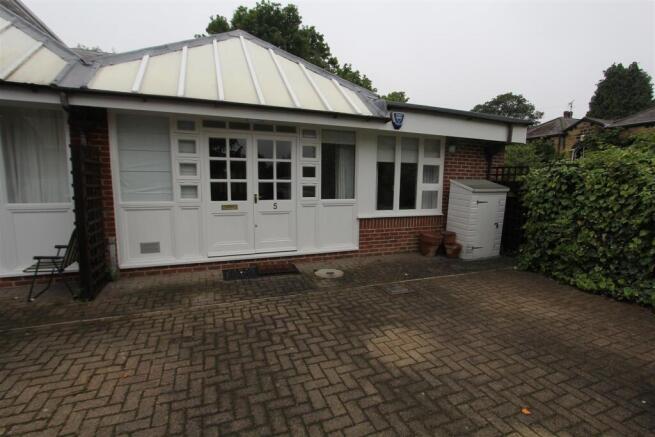 Charming entrance with private paved patio...