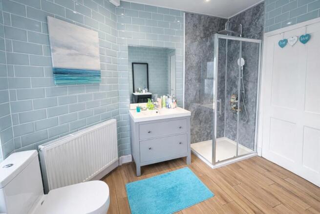 Bright, modern bathroom with a framed glass sho...