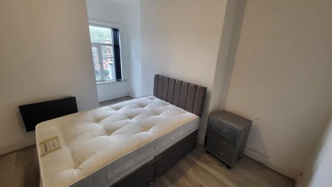 Bright, neatly presented bedroom with a comfort...