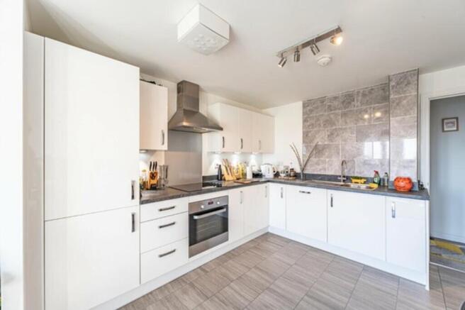 A modern and bright kitchen with ample storage ...