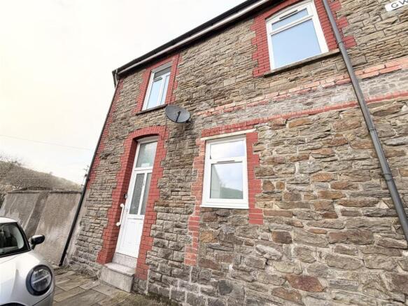 Charming stone house with classic red brick tri...