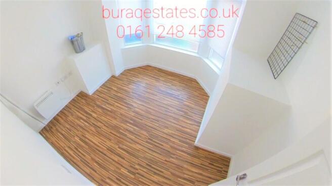 Bright, freshly painted bedroom with clean wood...