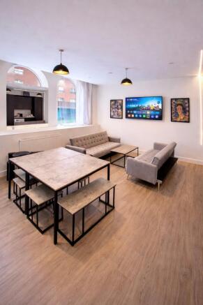 Bright, modern communal lounge with two matchin...