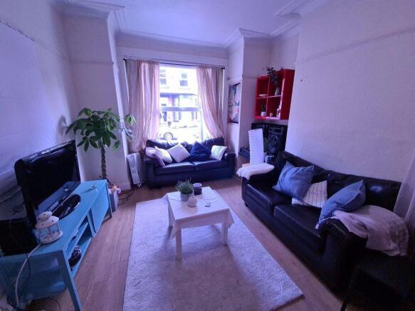 A bright and welcoming living room with large w...