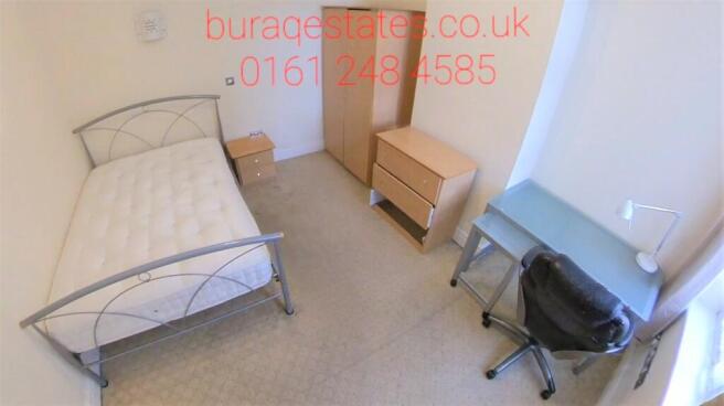 Bright, simply furnished bedroom with a single ...