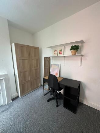 A tidy study space featuring a black desk with ...