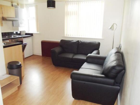 Bright, modern living area with matching black ...