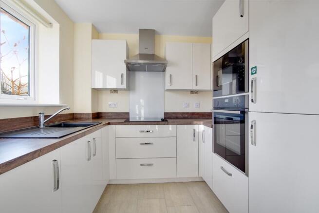 a kitchen with white cabinets