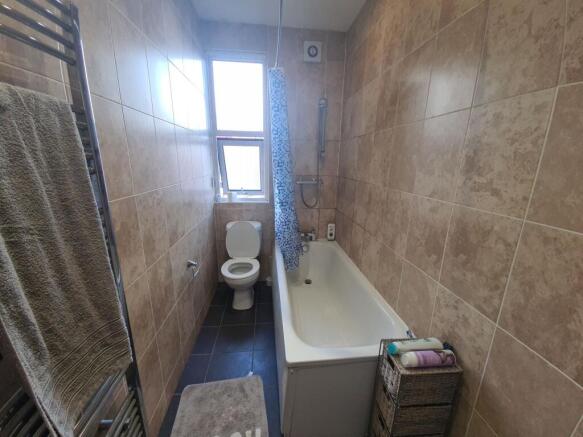 A well-maintained bathroom featuring a full-siz...