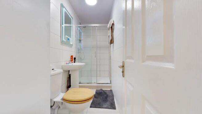 Bright and clean bathroom featuring a modern sh...