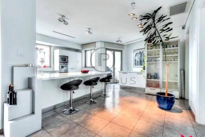 A modern, bright kitchen with a large island, bar 
