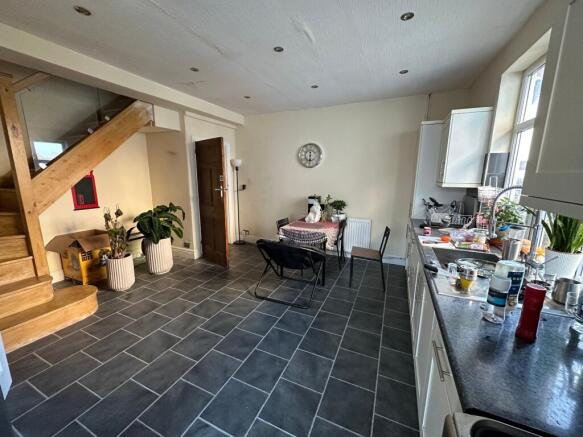 Open-plan kitchen and dining area with modern d...