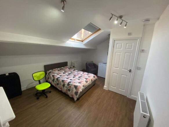 Bright and spacious master bedroom featuring a ...
