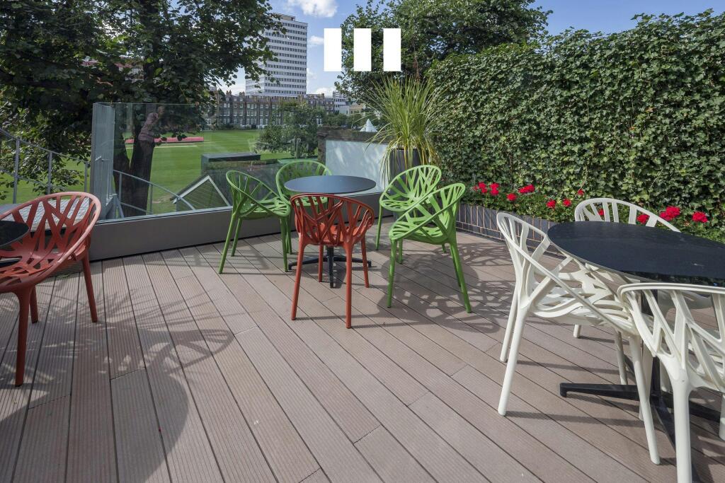 8 City Road Modern Rooftop Terrace With Colorful Seating And Lush Views.jpg