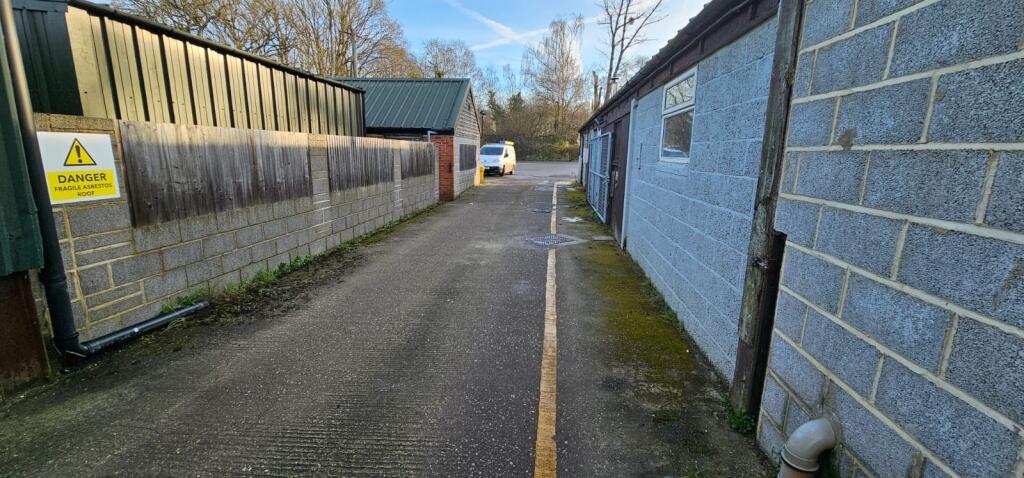LOOKING TOWARDS ENTRANCE TO SITE. UNITS 1 1212A ON RIGHT.JPG