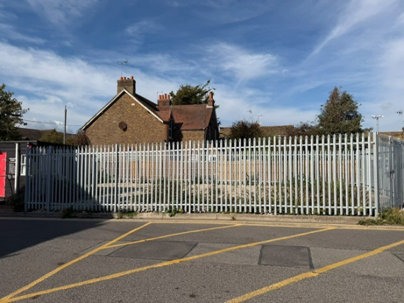A large plot of land, with fencing around it.