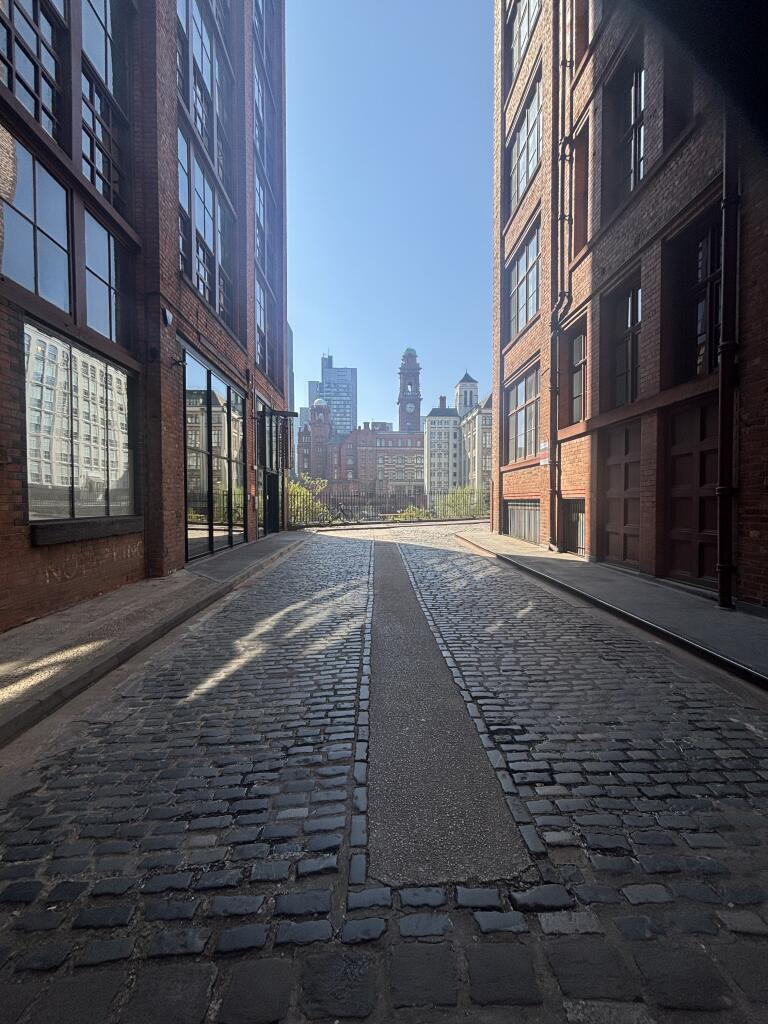 Entrance next to the cobbled path