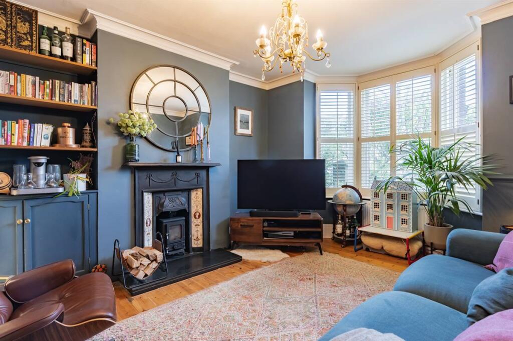 Living room with cast-iron log burner and bay window