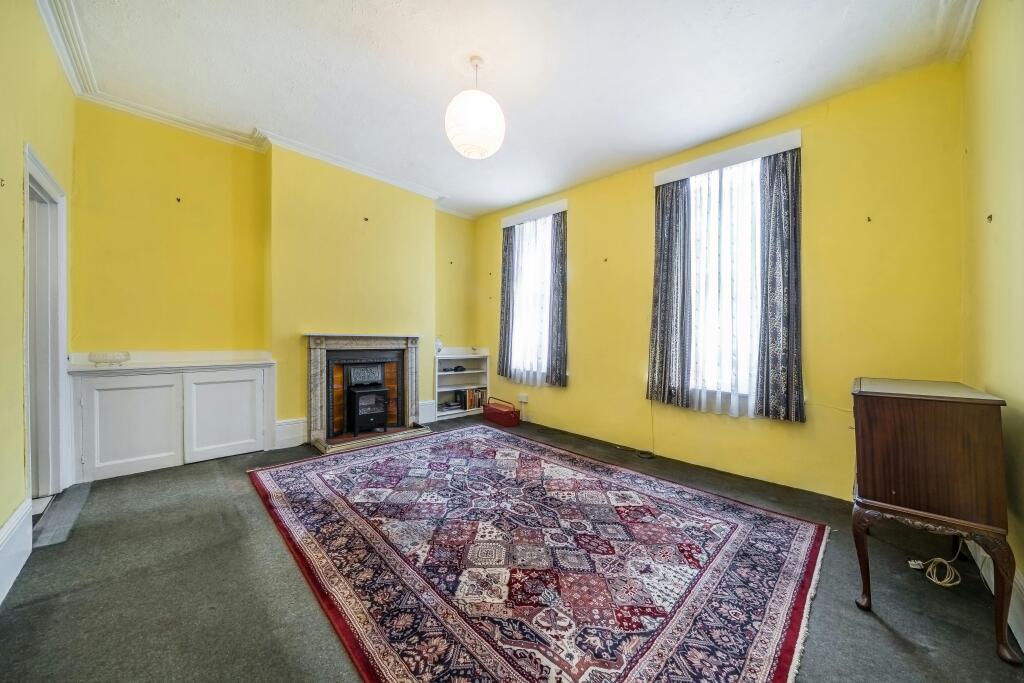 255 Grays Inn Road Bright Living Room With Fireplace And Large Windows.jpg