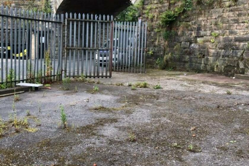 A large plot of land, with metal fencing around it.