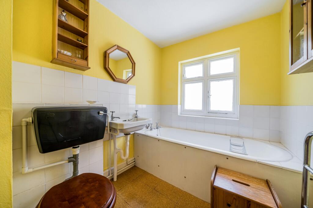 255 Grays Inn Road Bright Bathroom With Yellow Walls And Traditional Fixtures.jpg
