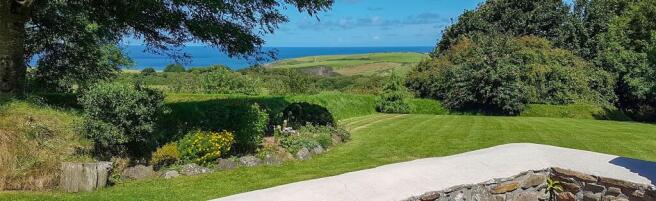 Coastal location with 18 Acres of landscaped gardens, pastures and woodland.