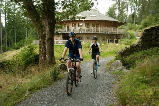 1961_Couple riding out from the visitor centre on the family trail at Coed y Brenin_Natural Resources Wales_No Restrictions_n_a.jpg