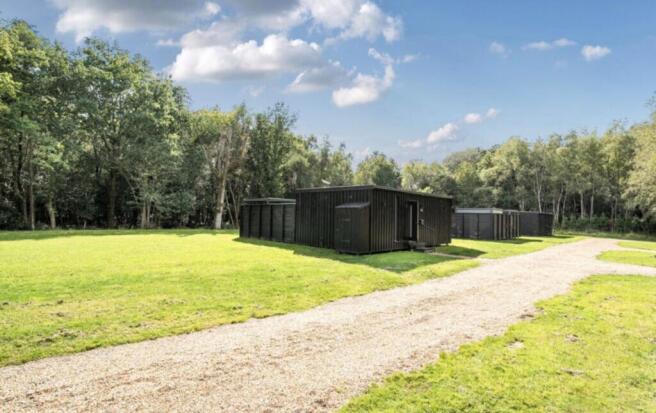 Existing Cabins Against Woodland