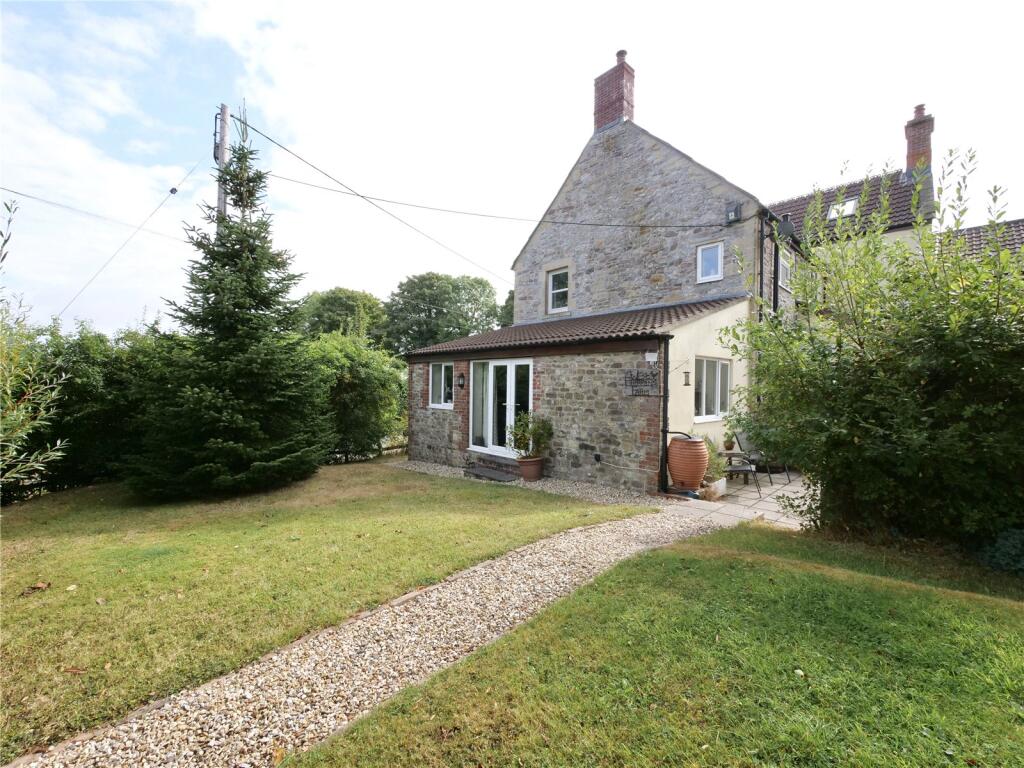 Main image of property: A beautifully positioned four-bedroom farmhouse with paddock, outbuildings and far-reaching countryside views.