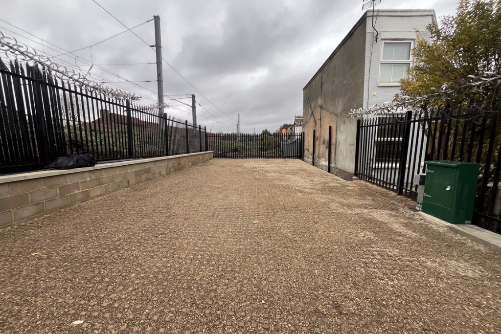 A large plot of land, with metal fencing around it.