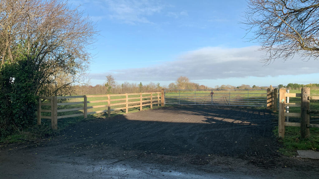 Direct access via a double-gated entrance set-back from the road.