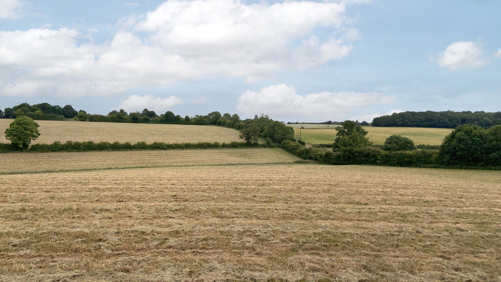 Land for sale with extensive road frontage.