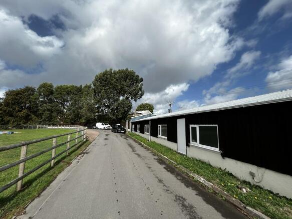 Photo 5. Front elevation overlooking estate road and paddock.