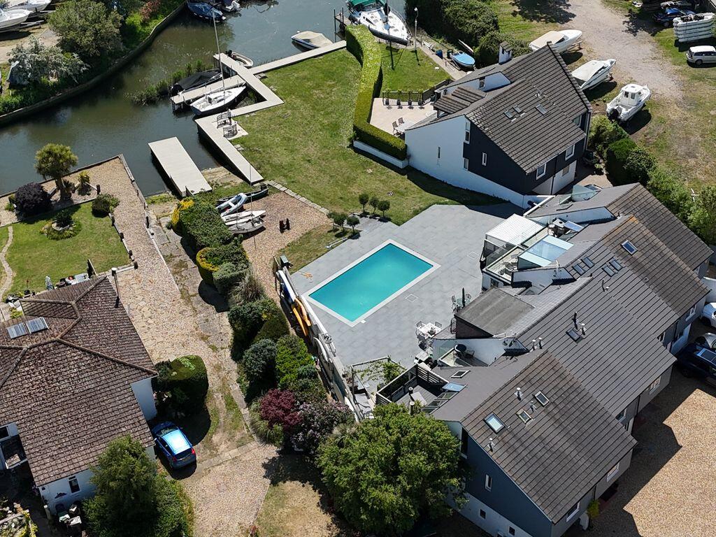 Main image of property: RARE RIVERSIDE HOME WITH HEATED POOL