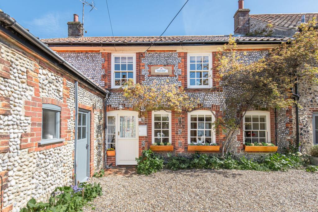 Main image of property: A Delightful Flint and Brick Period Property, Tucked Away in the Heart of the Charming Coastal Village of Blakeney