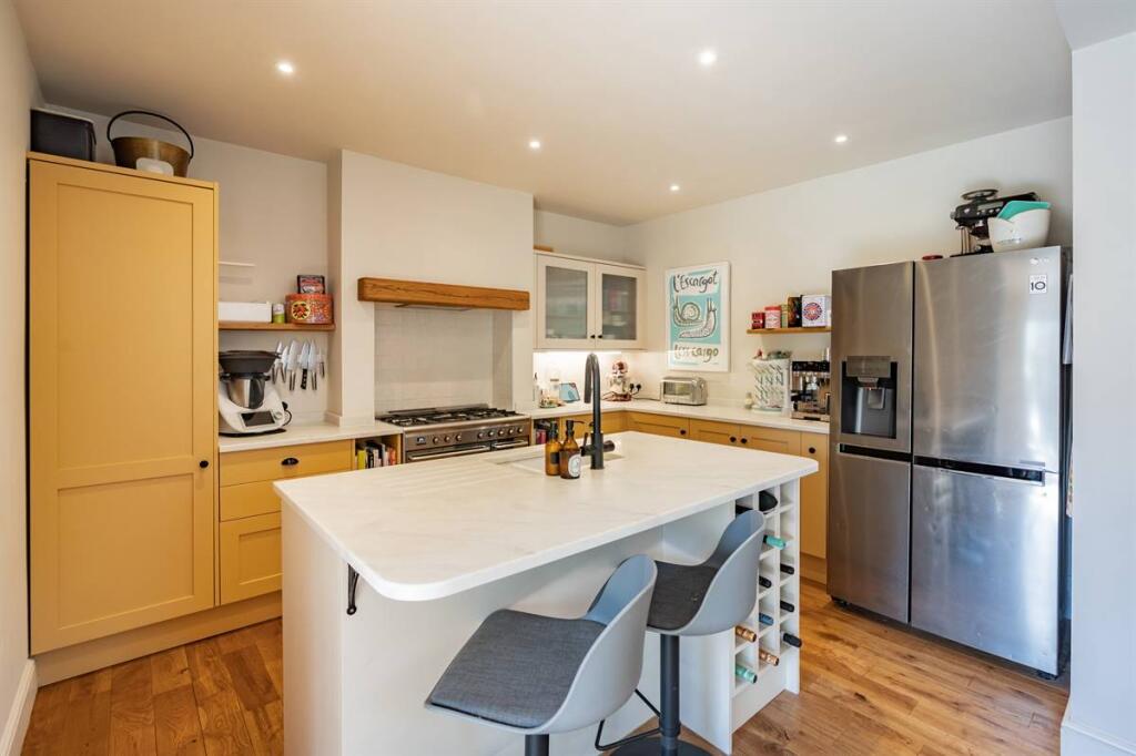 Modern kitchen with quartz island and breakfast seating