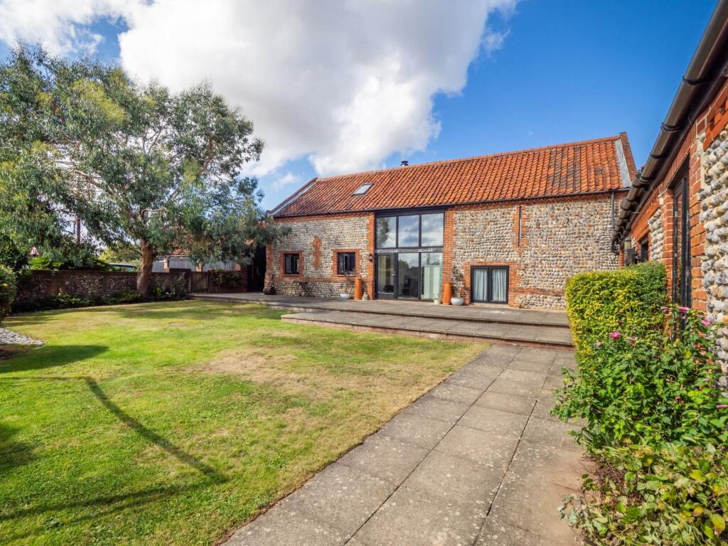Main image of property: A captivating brick and flint barn conversion with independent annex and a true North Norfolk coastal lifestyle.