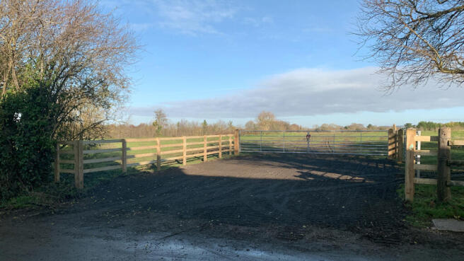 Direct access via a double-gated entrance set-back from the road.