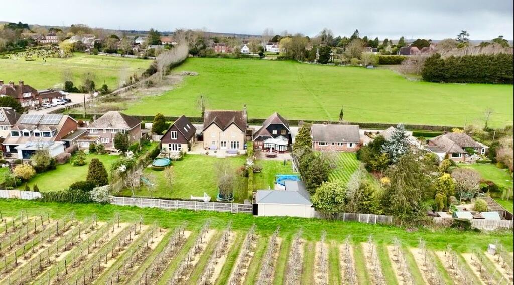 Main image of property: Impressive family home boasting a generous garden and rural views in a sought after village