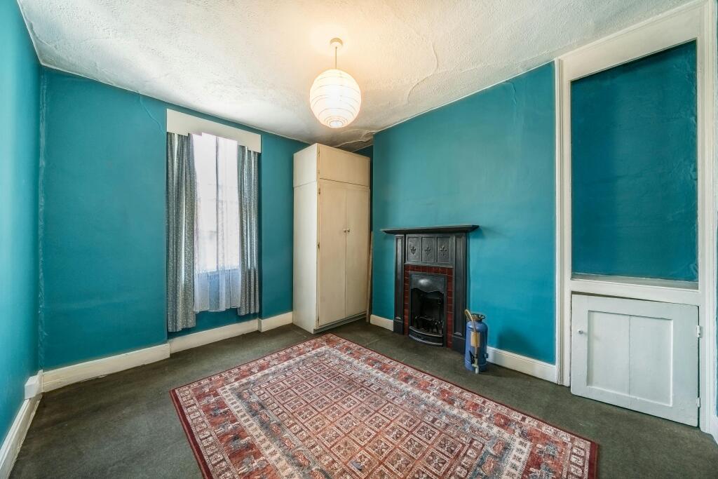 255 Grays Inn Road Cozy Room With Vintage Fireplace And Vibrant Walls.jpg