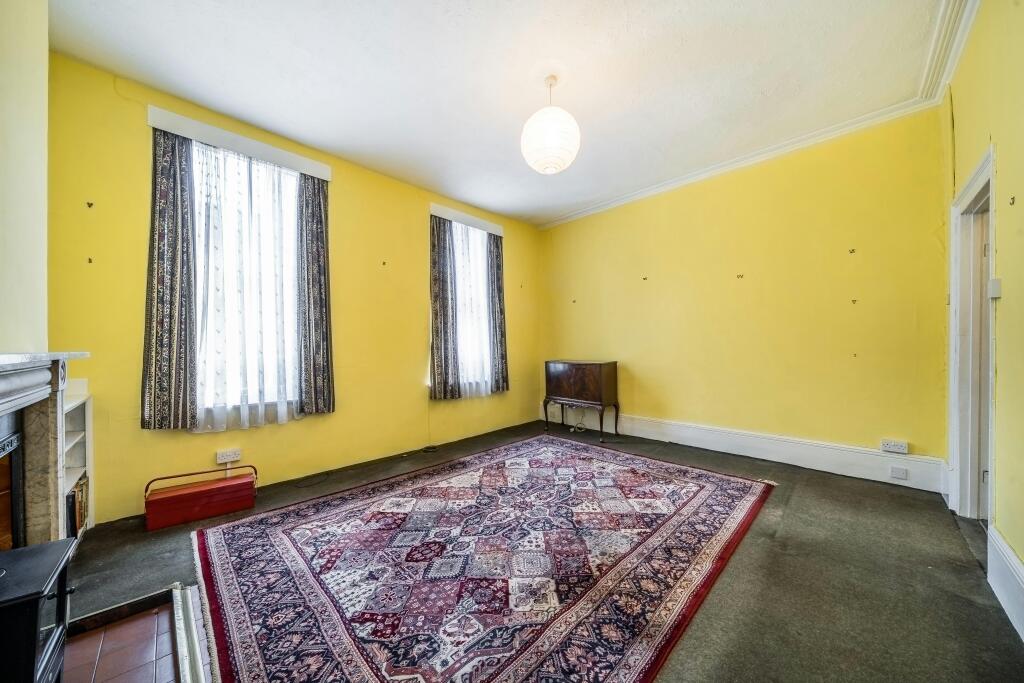 255 Grays Inn Road Bright Room With Yellow Walls And Large Patterned Rug.jpg