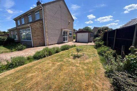 side garden, driveway and garage