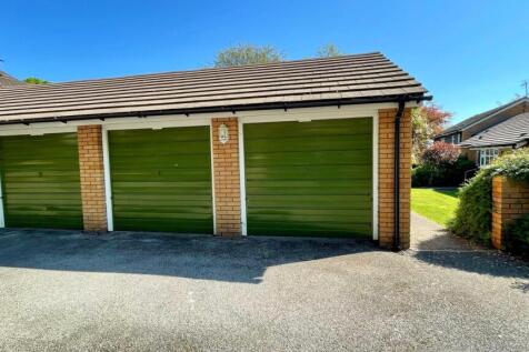 The front has 2 single garages in a separate block