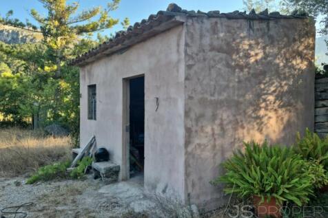 Land with small house 