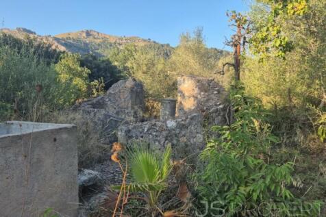 Land with small house 