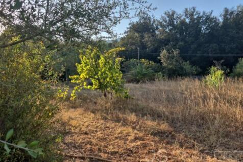 Land with small house 