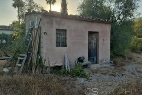 Land with small house 